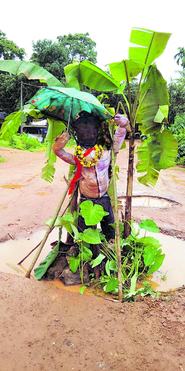 Auto drivers staged a protest against the pathetic condition of the Puttur-Mundoor Road by placing a scarecrow on the road.