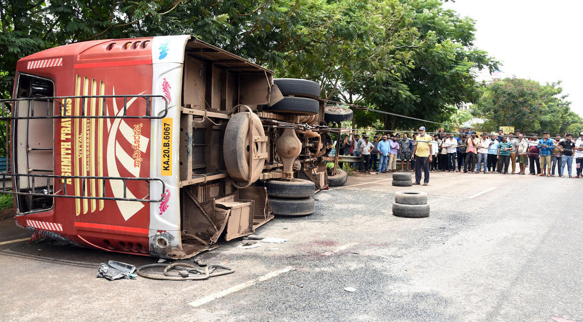 A private bus overturned and fell on a moving car at Adyar on the outskirts of Mangaluru on Wednesday.