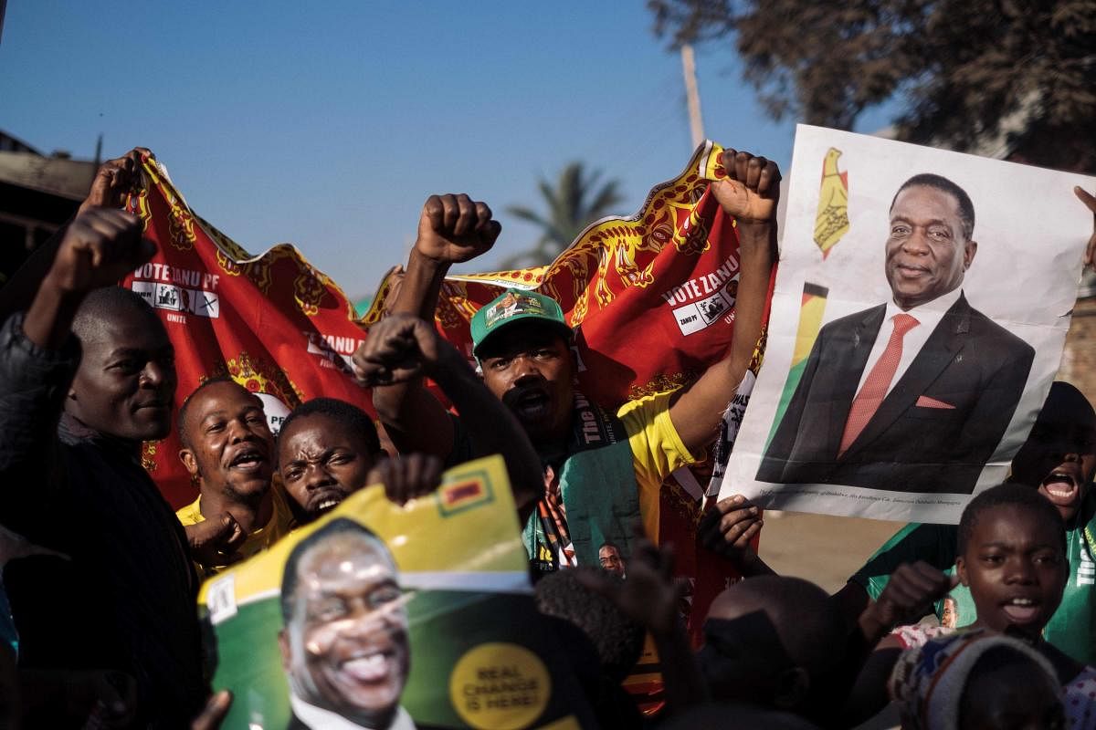 Supporters of the newly reelected Zimbabwe President Emmerson Mnangagwa celebrate in Mbare, Harare, on August 3, 2018. AFP