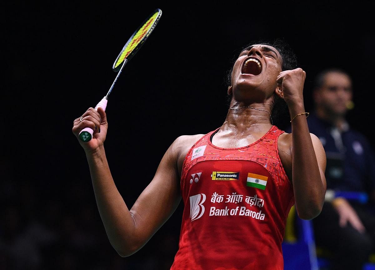 P V Sindhu celebrates after defeating Nozomi Okuhara of Japan in their women's singles quarterfinal of the badminton World Championships in Nanjing on Friday. AFP