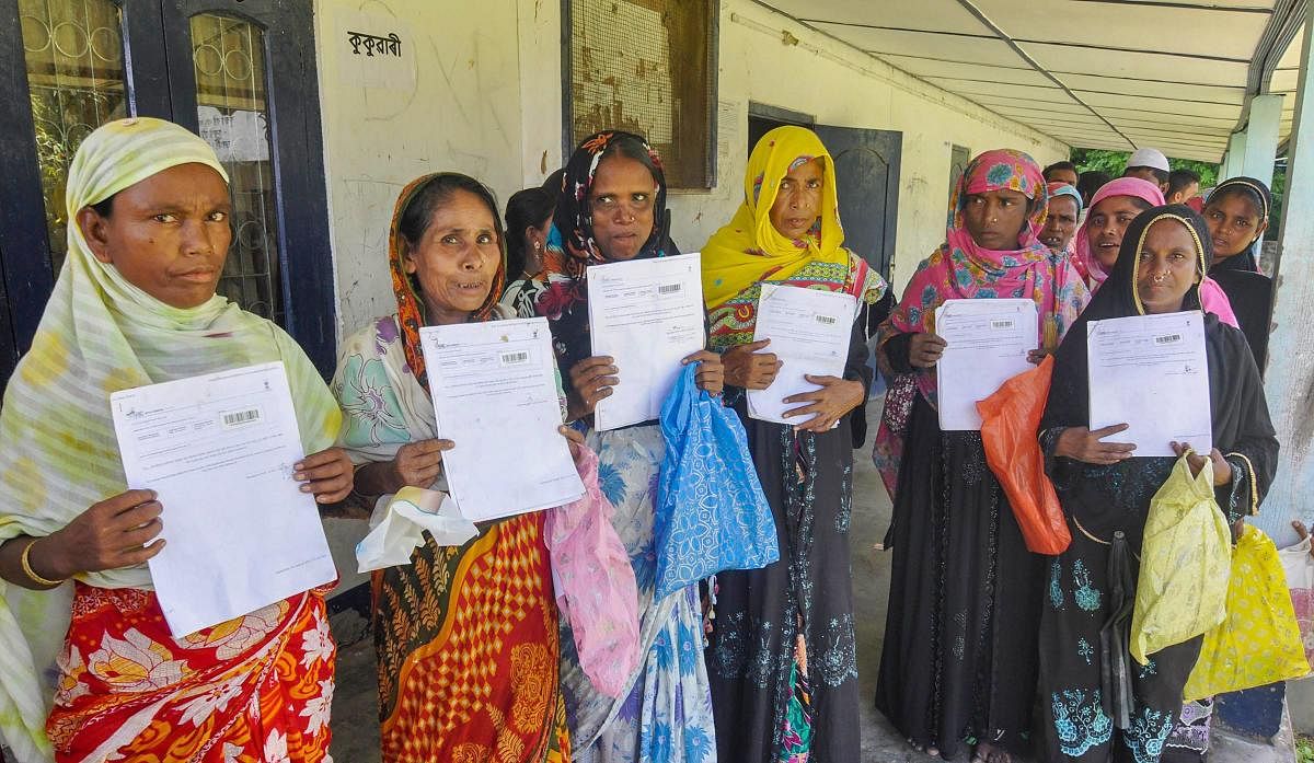 People queue at an office to verify and check their names in the final draft of the National Register of Citizens (NRC), at Morigoan on Saturday, Aug 4, 2018. (PTI Photo)
