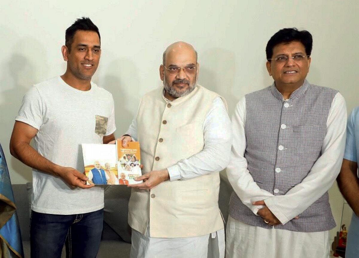 BJP President Amit Shah meets Indian cricketer M S Dhoni during his 'Sampark for Samarthan' campaign to generate awareness about the NDA government's achievements, in New Delhi on Sunday. PTI photo
