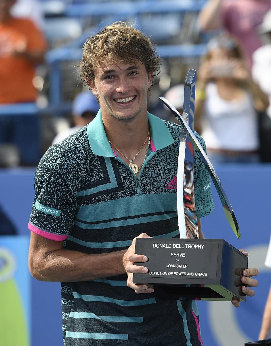 Alexander Zverev of Germany poses with the trophy after beating Alex de Minaur, of Australia, in the men's finals of the Citi Open. AFP