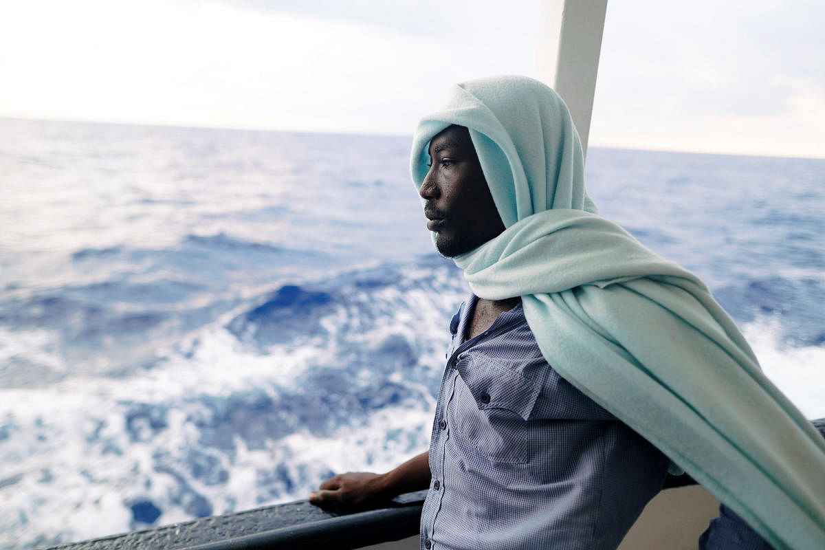 A migrant stands on board NGO Proactiva Open Arms rescue boat in central Mediterranean Sea, August 5, 2018. REUTERS