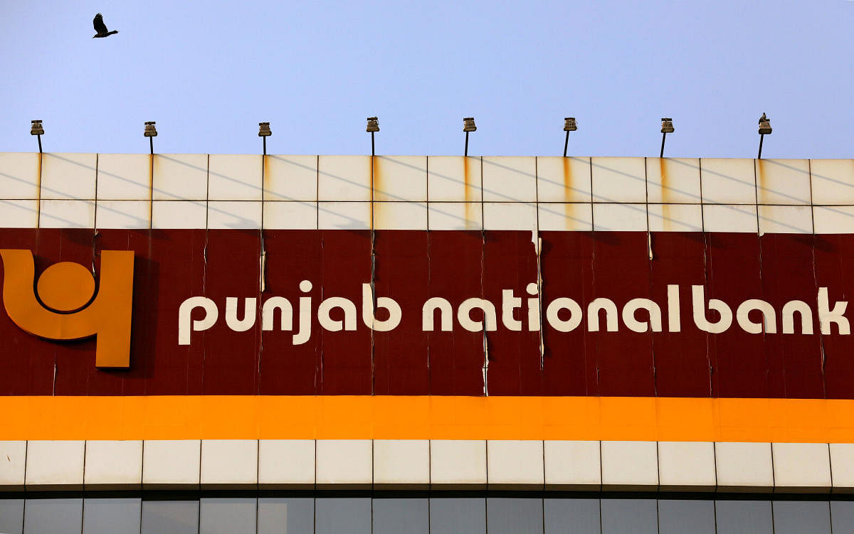 FILE PHOTO: A bird flies past the logo of Punjab National Bank installed on the facade of its office in Mumbai, India, February 21, 2018. REUTERS/Danish Siddiqui/File photo GLOBAL BUSINESS WEEK AHEAD