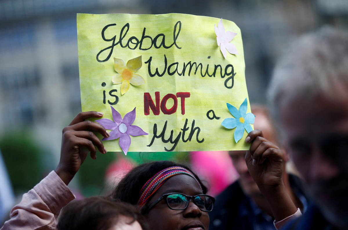 People take part in protests ahead of a G20 summit in Hamburg, Germany July 2, 2017. Placard reads "Global Warming is NOT a Myth". (REUTERS File Photo)