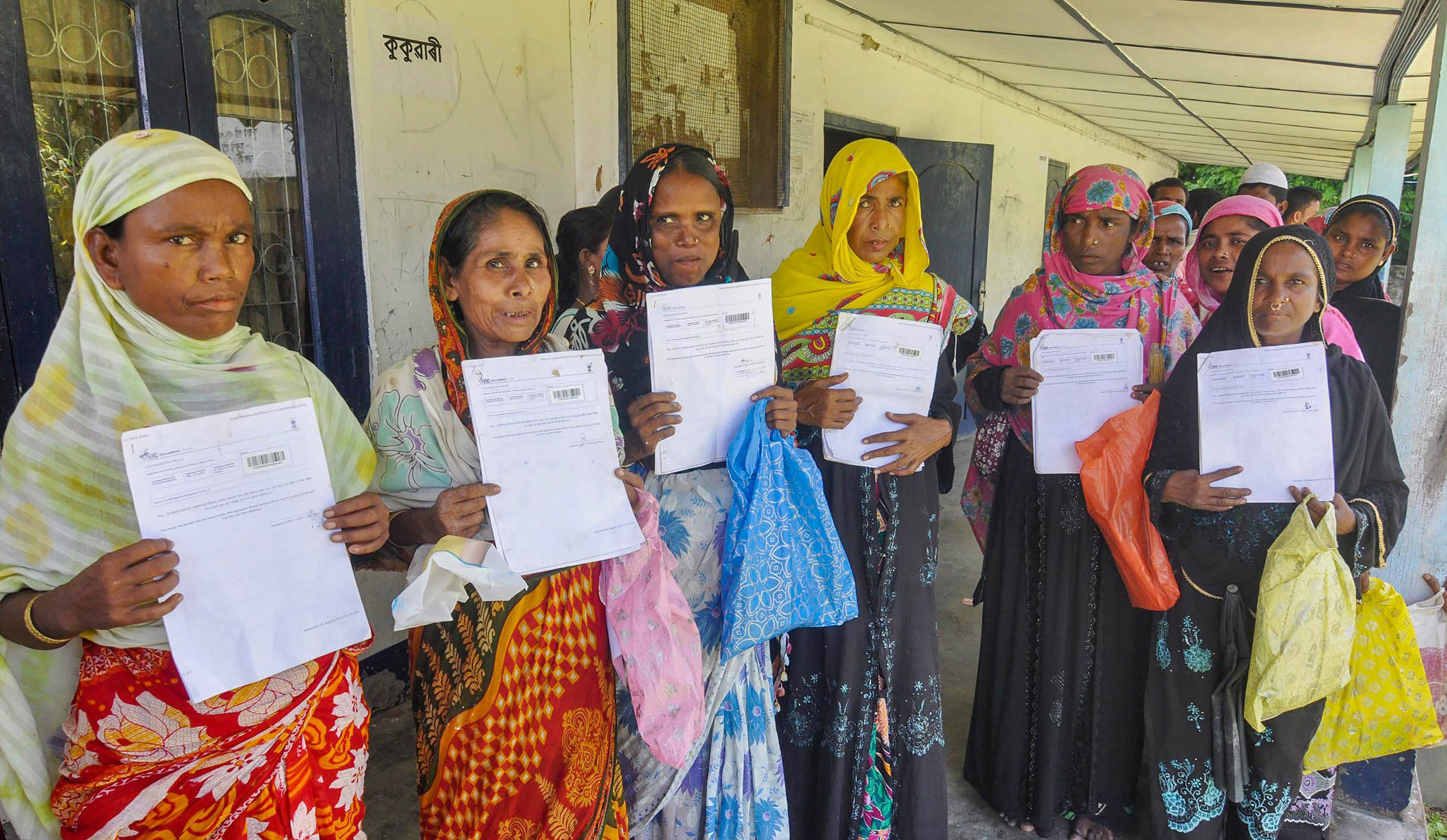 People queue at the office to verify and check their names in the final draft of the National Register of Citizens (NRC), at Morigoan. PTI