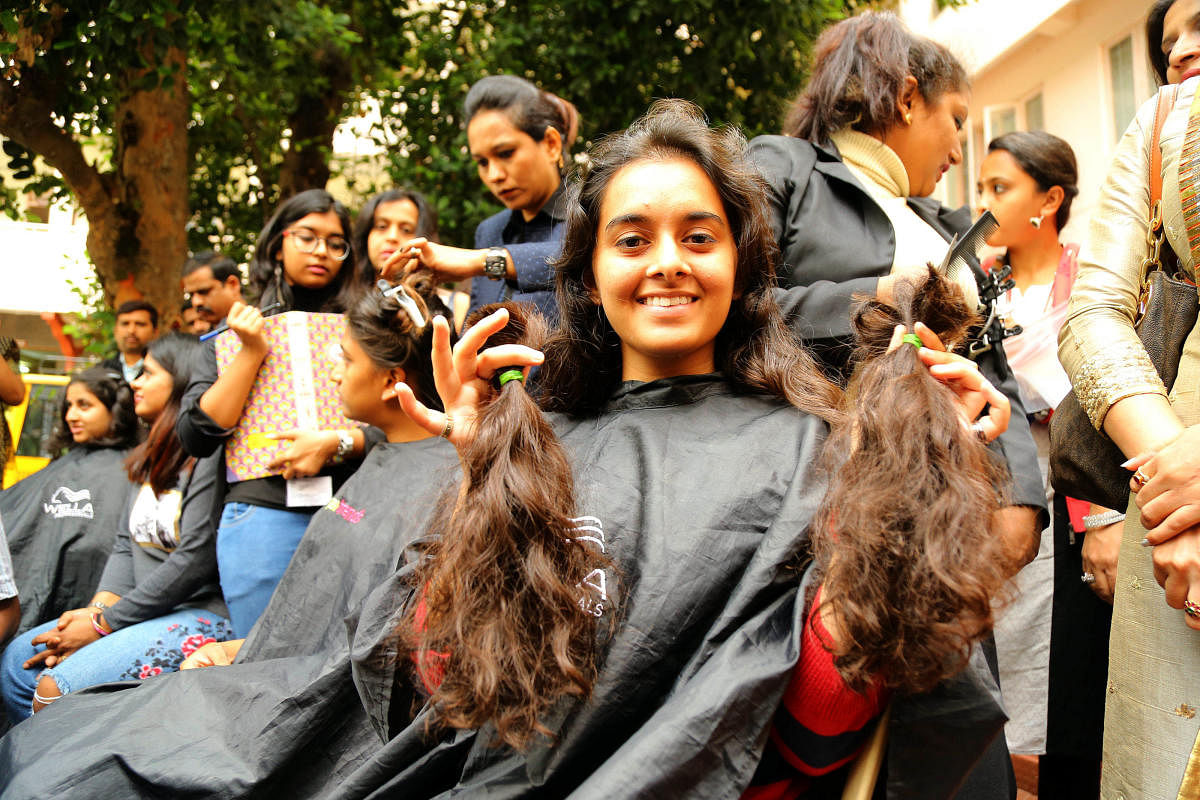 Students of Mount Carmel College donating their hairs during the Gift hair Gift confidence campaign for Cancer patients at College premises organised by The Cherian Foundation in Bengaluru on Wednesday 09th August 2018.