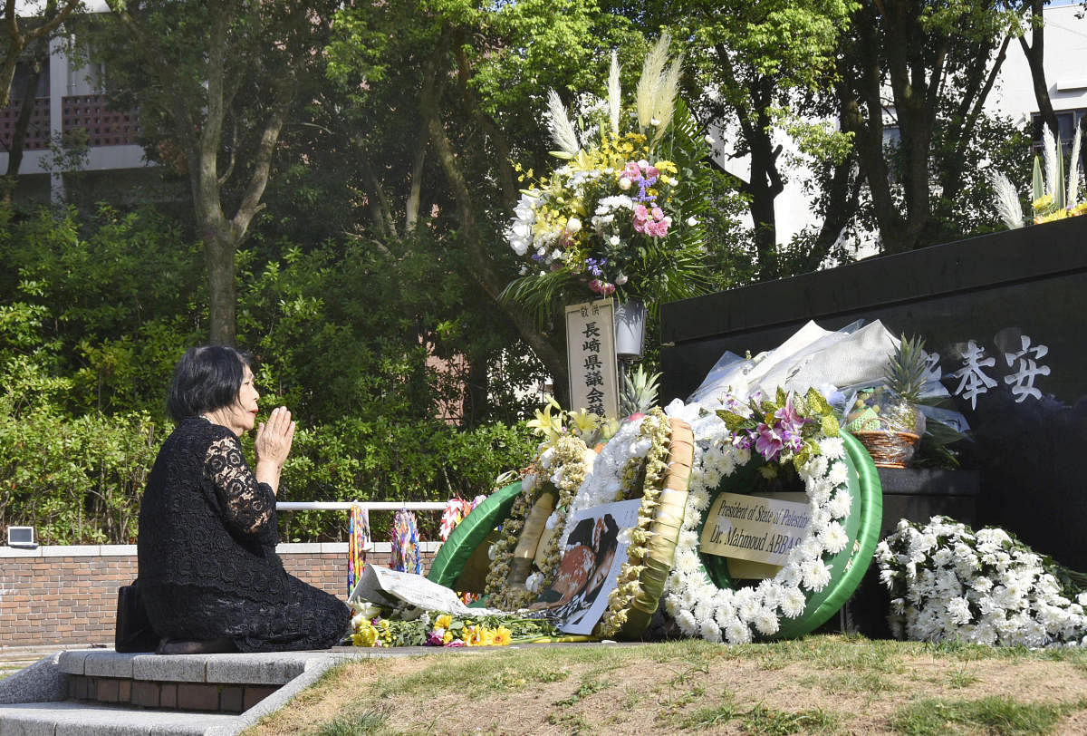 A woman prays for victims of the 1945 atomic bombing on a day commemorating the 73rd anniversary of the bombing at Nagasaki's Peace Park, western Japan, in this photo taken by Kyodo August 9, 2018. (Kyodo/via REUTERS)