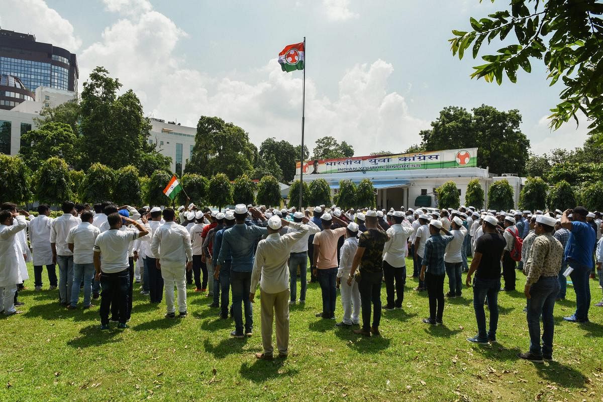 Indian Youth Congress members salute party flag during their Foundation Day celebrations, at IYC National Office in New Delhi on Thursday, Aug 9, 2018. (PTI File Photo)
