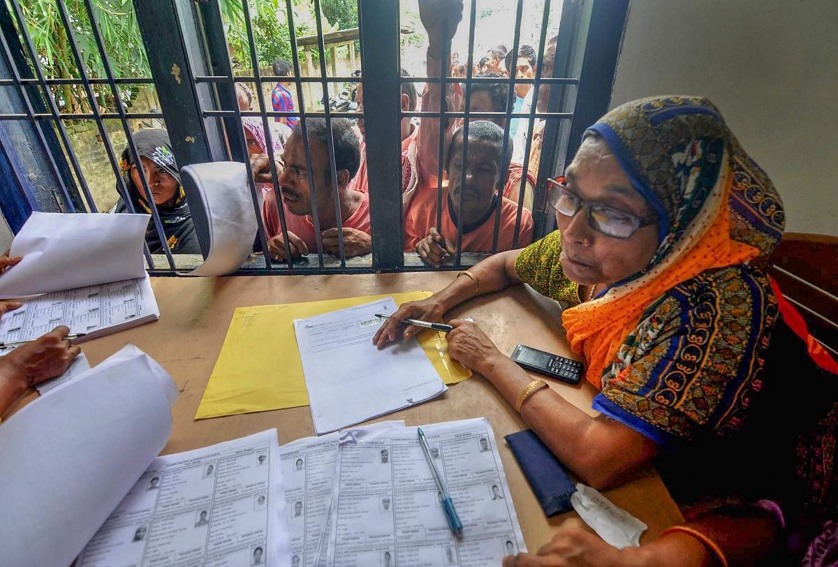 People wait in a queue to check their names on the final draft of the state's National Register of Citizens after it was released, at an NRC Seva Kendra, in Morigaon. (PTI File Photo)