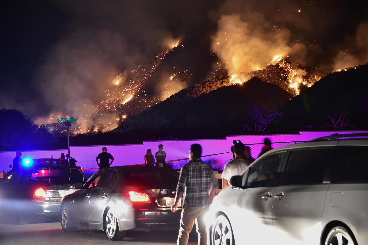 People watch flames from the 'Holy Fire' outside Glen Ivy Hot Springs in Corona, California, southeast of Los Angeles, on August 10, 2018. AFP