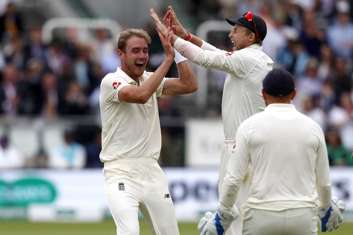 PUMPED up: England’s Stuart Broad (left) celebrates with skipper Joe Root after dismissing Dinesh Karthik on Sunday. AFP