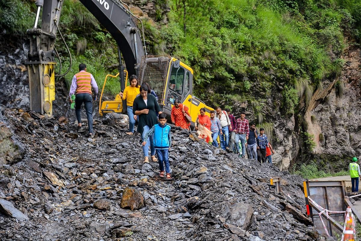 Restoration works underway after a major landslide on the national highway near Malyana due to heavy rains, in Shimla on Saturday, Aug 11, 2018. (PTI Photo)