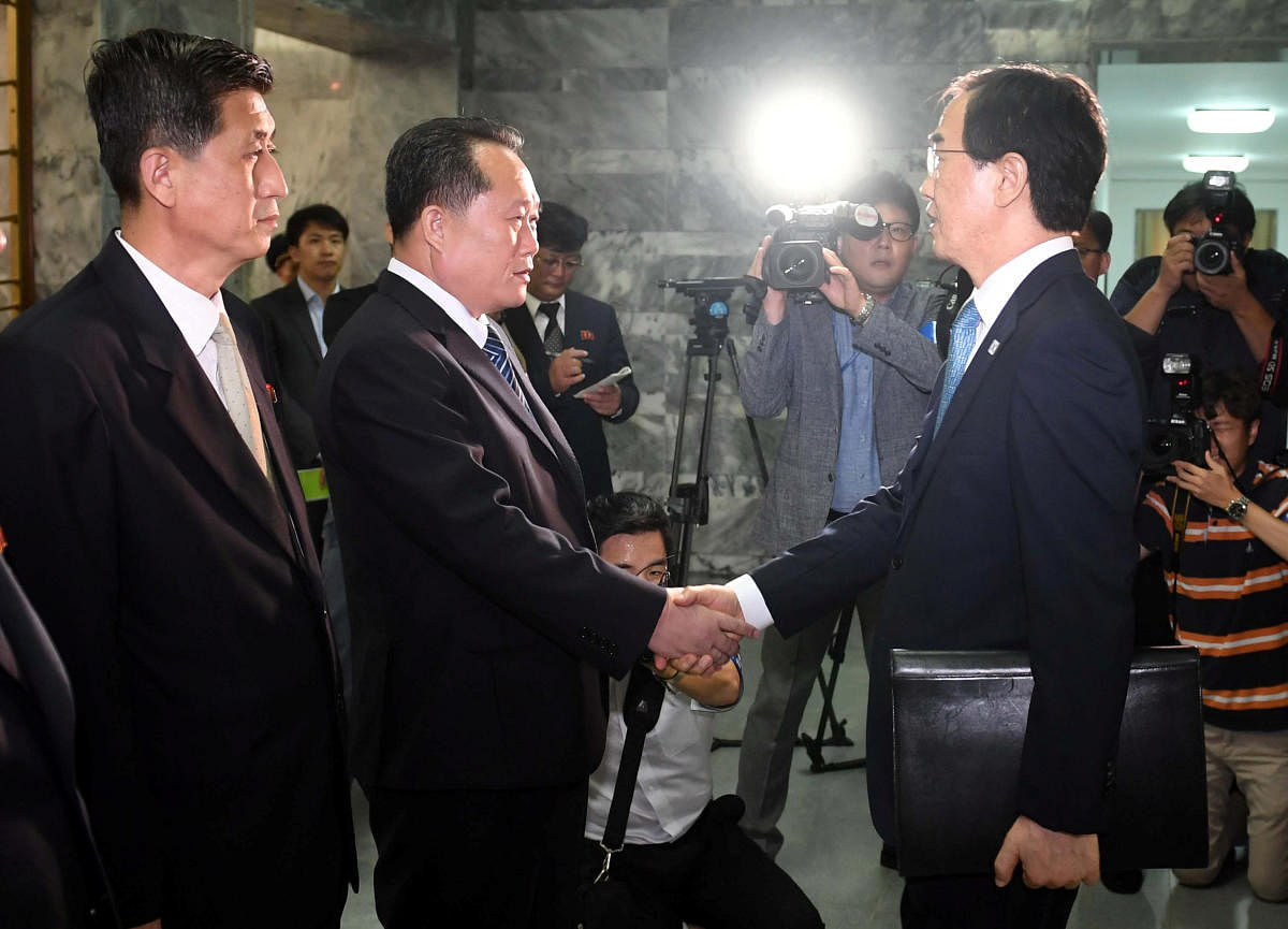 South Korean Unification Minister Cho Myoung-gyon shakes hands with his North Korean counterpart Ri Son Gwon before their meeting at the truce village of Panmunjom inside the demilitarized zone, North Korea, on Monday. (Yonhap via REUTERS)