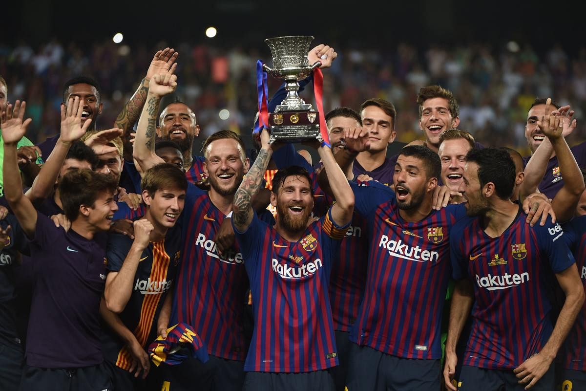 Barcelona with the trophy after winning the Spanish Super Cup on Sunday. AFP