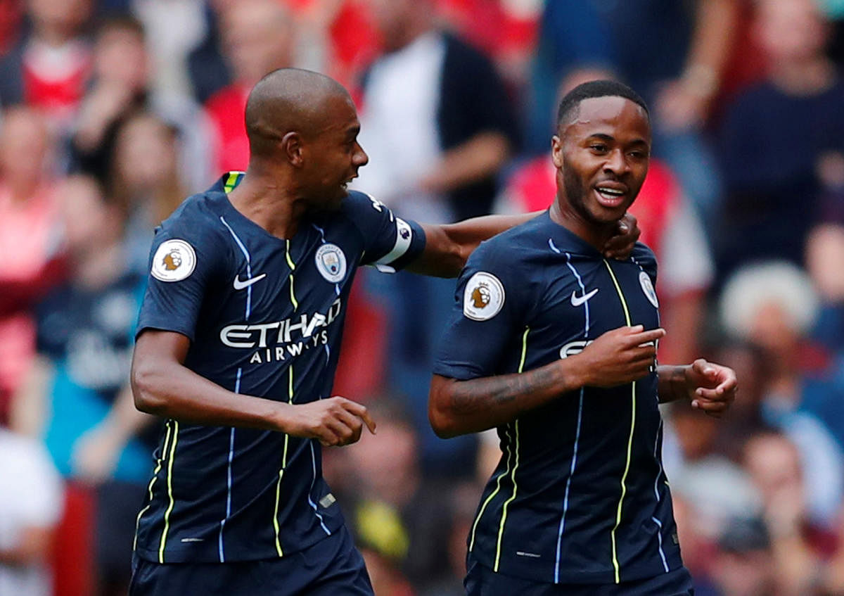 Manchester City’s Raheem Sterling celebrates with Fernandinho after scoring their first goal. Reuters