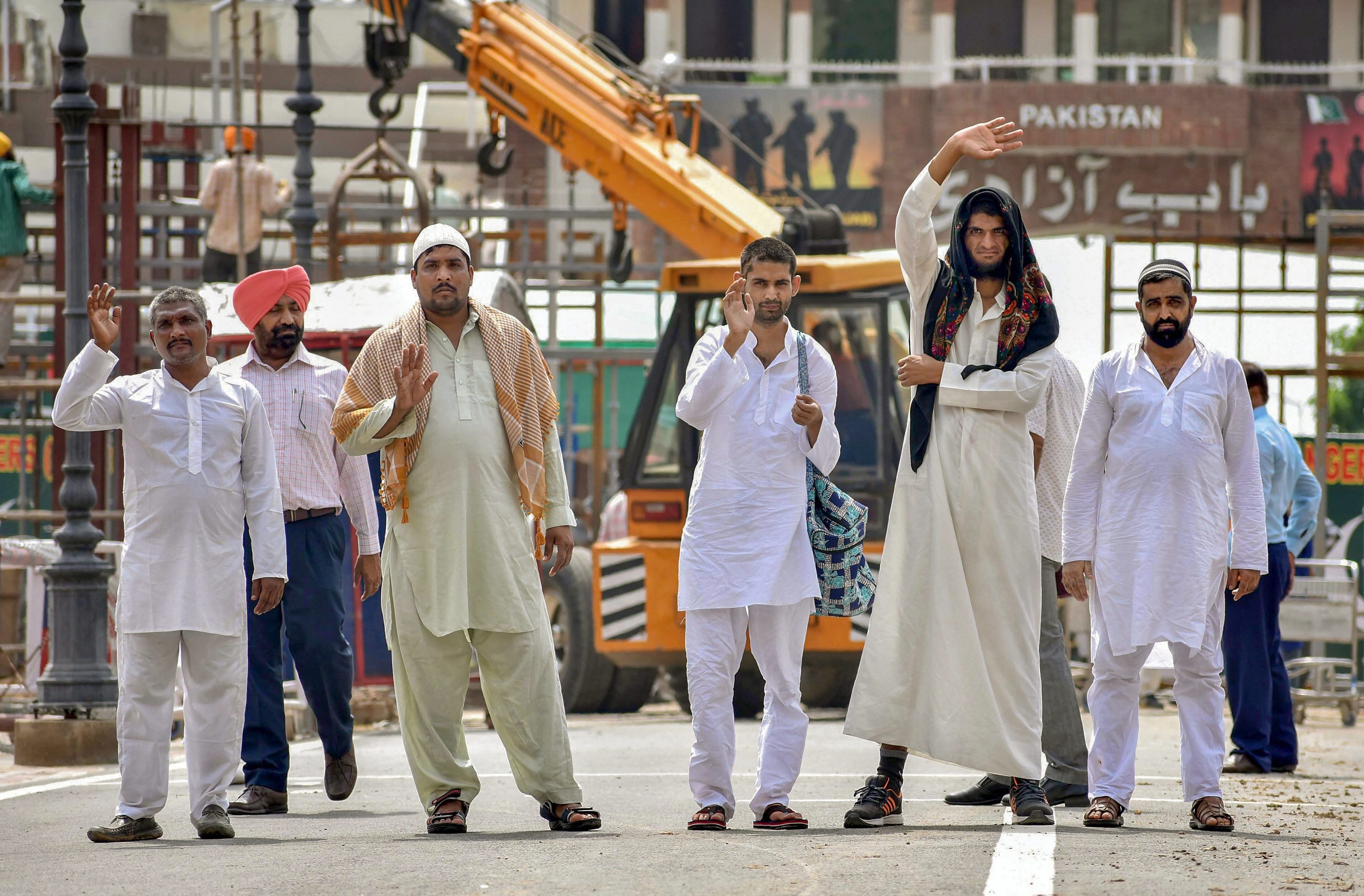 Pakistani prisoners prepare to cross Wagah border as they return after their release by India, ahead of Independence Day, in Attari on Monday. PTI