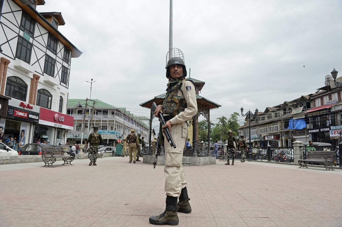 An Indian paramilitary trooper stands guard along a street as security measures beefed-up ahead of Indian Independence day in Srinagar. AFP photo