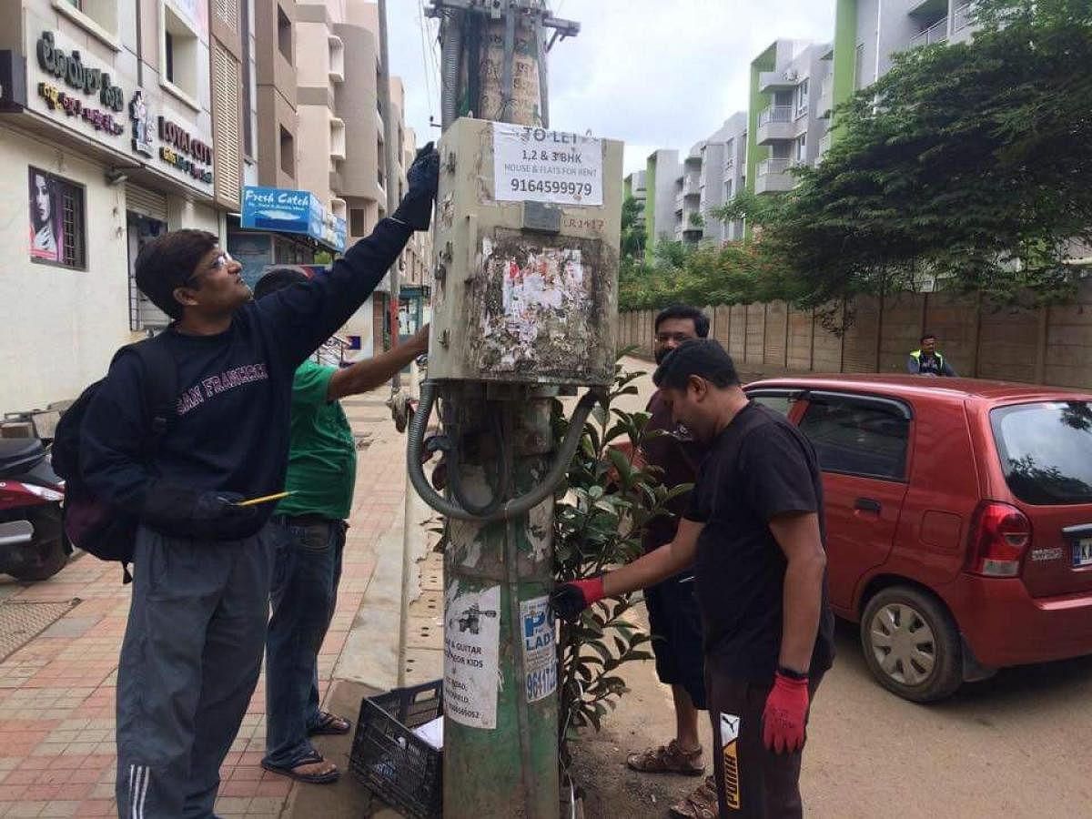 Residents remove posters in Whitefield. 