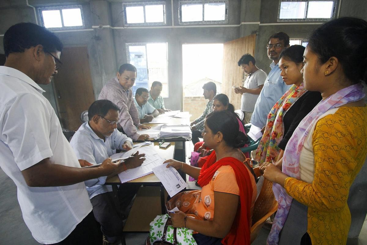 People whose names were missing in the final draft of National Register of Citizenship (NRC) published on 30th July 2018, filling new enrollment forms at an NRC Seva Kendra, in Guwahati on Saturday. PTI Photo