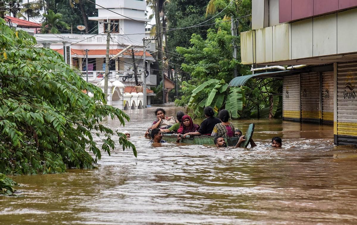 People being rescued from a flood-affected region following heavy monsoon rainfall, in Kochi on August 16. PTI