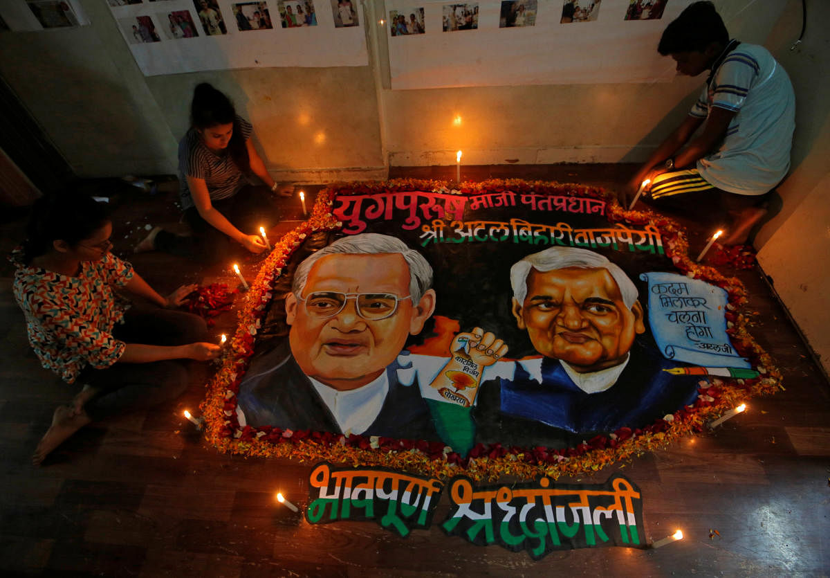 Students place candles around a painting featuring India's former prime minister Atal Bihari Vajpayee to pay him homage in Mumbai, India, August 16, 2018. (REUTERS)