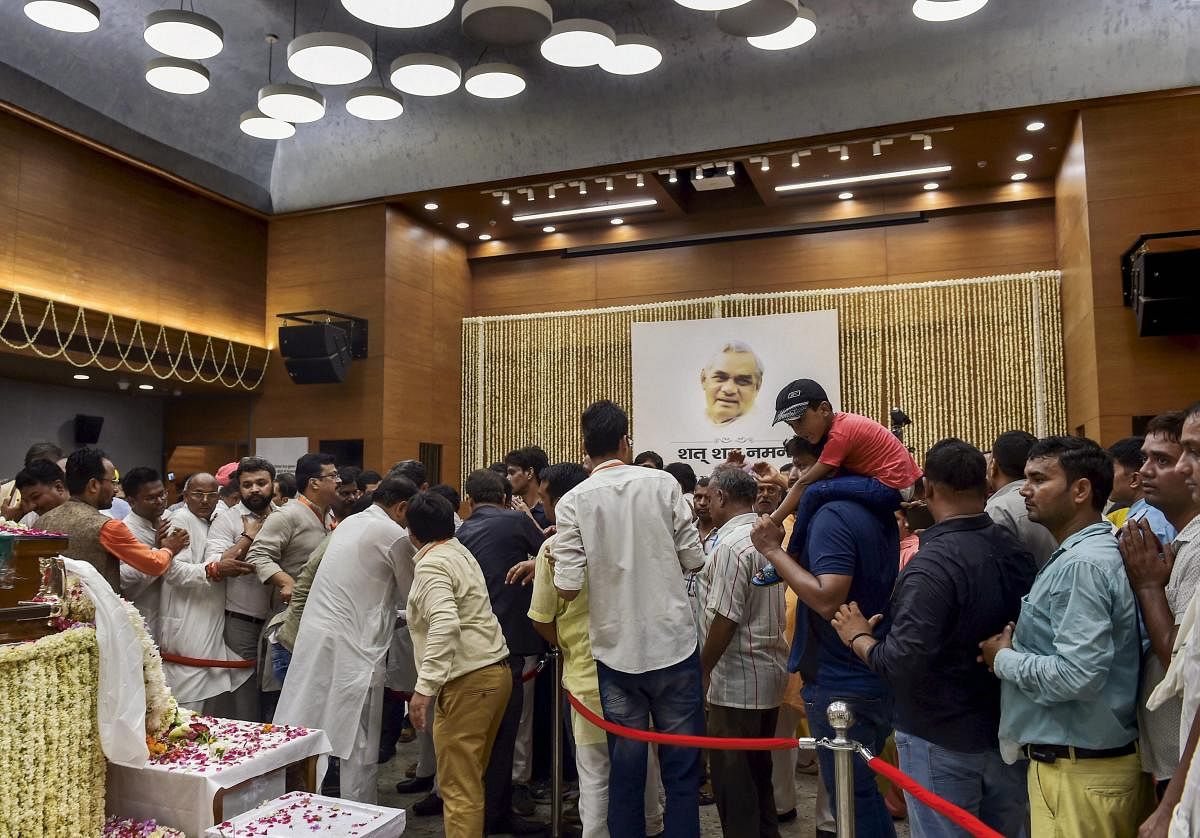 People pay their last respects to the mortal remains of former prime minister Atal Bihari Vajpayee at the BJP headquarters at DDU Marg in New Delhi on Friday, August 17, 2018. A seven-day state mourning has been announced as a mark of respect for the former prime minister Vajpayee who passed away at the age of 93, at Delhi's AIIMS hospital on Thursday. (PTI Photo)