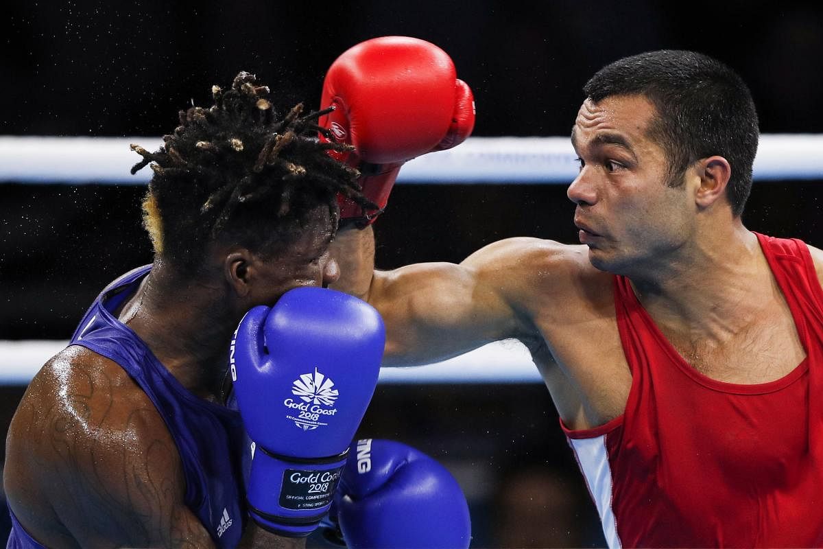 Indian boxer Vikas Krishan (red) is confident of doing well at the Asian Games. AFP File photo. 