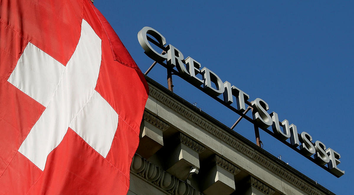 Switzerland's national flag flies next to the logo of Swiss bank Credit Suisse at a branch office in Luzern, Switzerland on October 19, 2017. Reuters