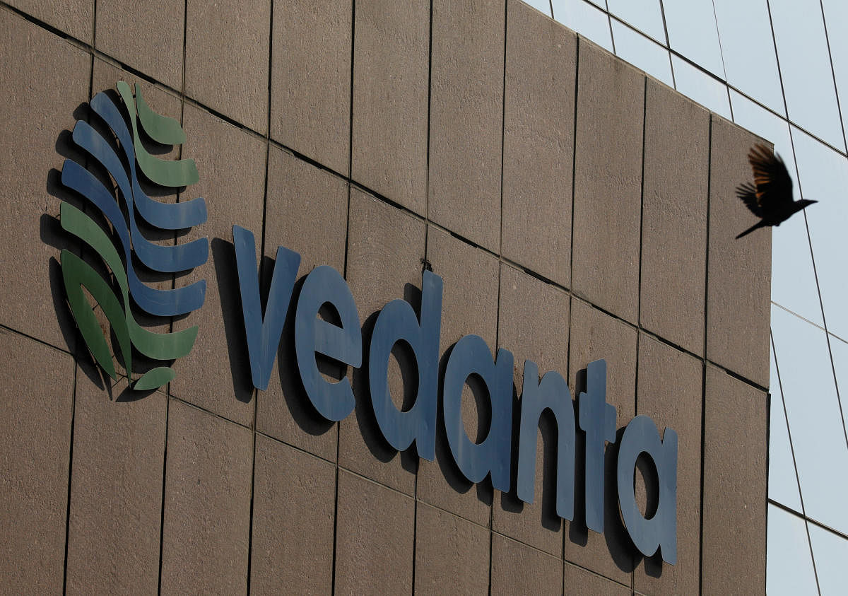 A bird flies past the logo of Vedanta installed on the facade of its headquarters in Mumbai. REUTERS