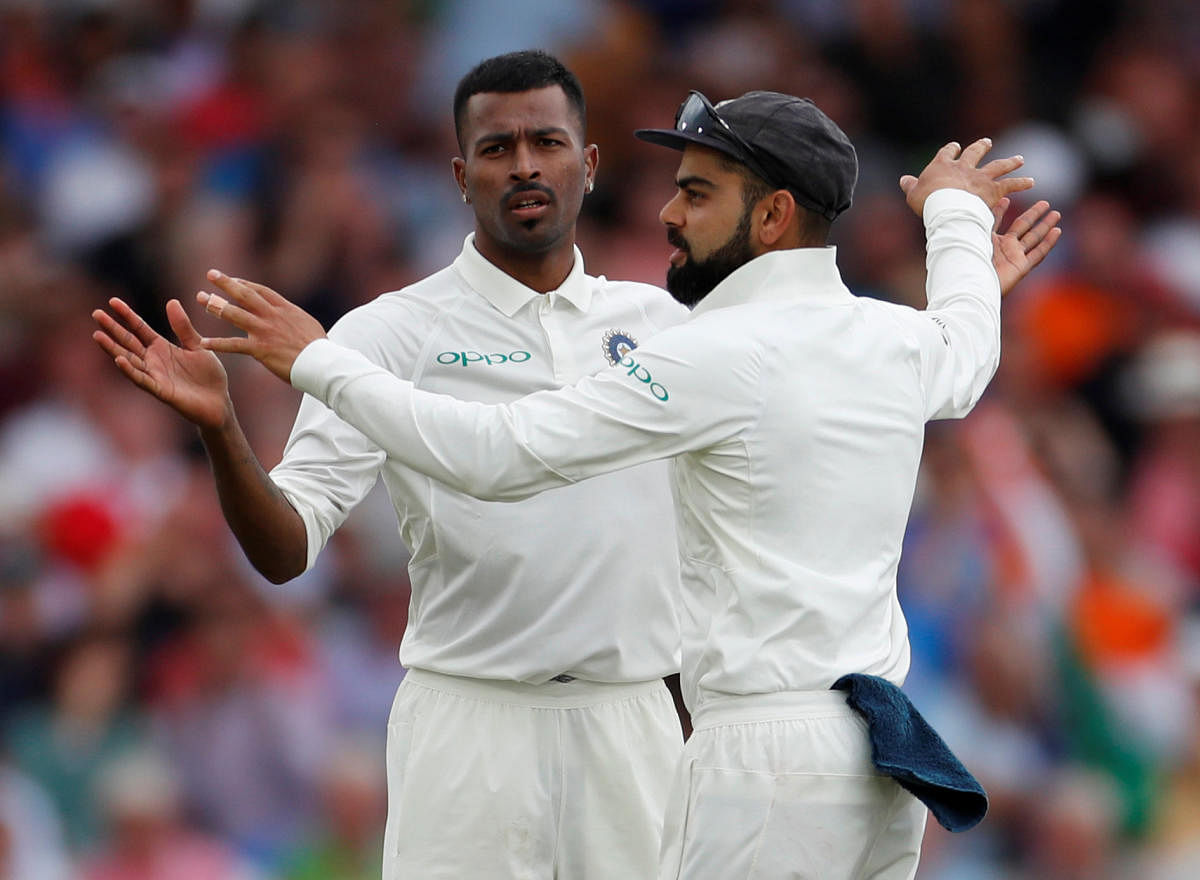 India's Hardik Pandya celebrates with Virat Kohli after taking the wicket of England's Adil Rashid. (Reuters)