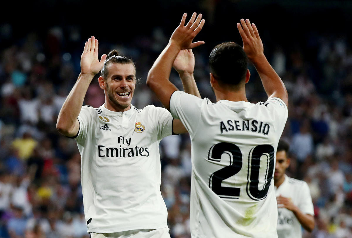 Real Madrid's Gareth Bale celebrates scoring their second goal with Marco Asensio. (REUTERS)