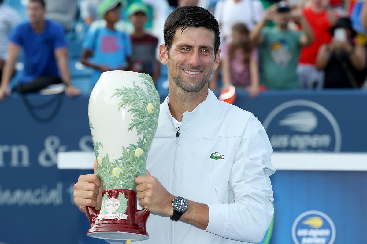 FINALLY! Novak Djokovic of Serbia poses with the trophy after defeating Roger Federer of Switzerland in the Cincinnati Masters final. AFP