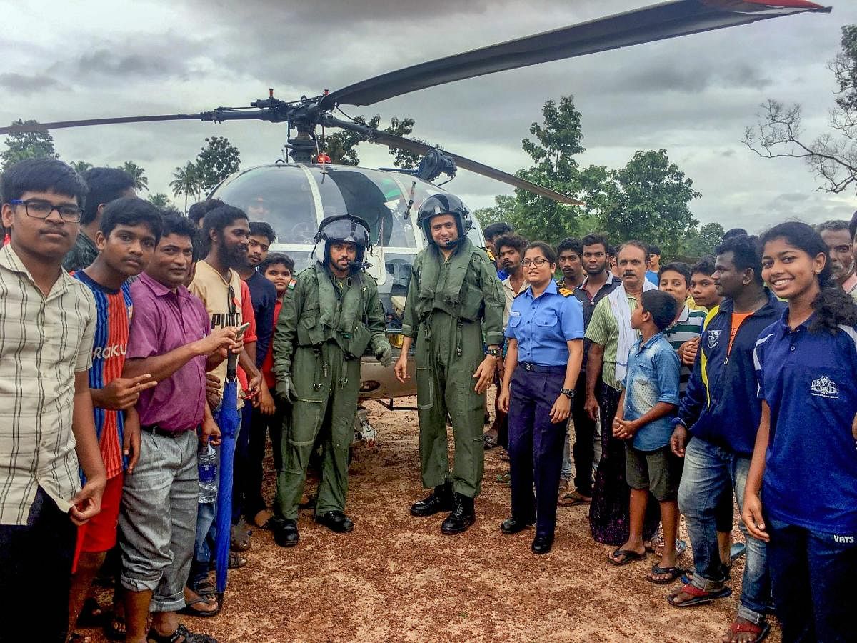 Rescue teams and local panchayat representatives involved in evacuating people from landslip-prone areas to relief camps at Kottayam district in Kerala, pose for a group photo on Monday, Aug. 20, 2018. (Coast Guard via PTI )