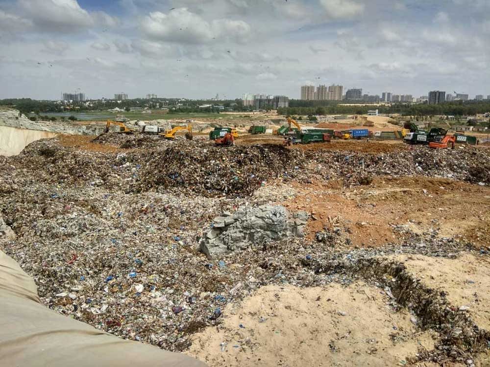 The abandoned quarry in Bellahalli village is being filled with mixed waste in violation of NGT orders.