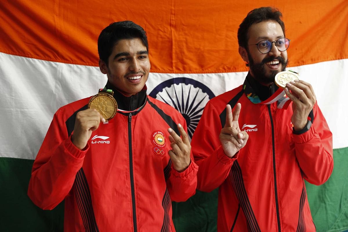 A RARE DOUBLE: Gold medallist Saurabh Chaudhary (left) and bronze medallist Abhishek Verma display their spoils in Palembang on Tuesday. BOTTOM: Veteran Sanjeev Rajput won silver in the 50M rifle event. REUTERS/PTI