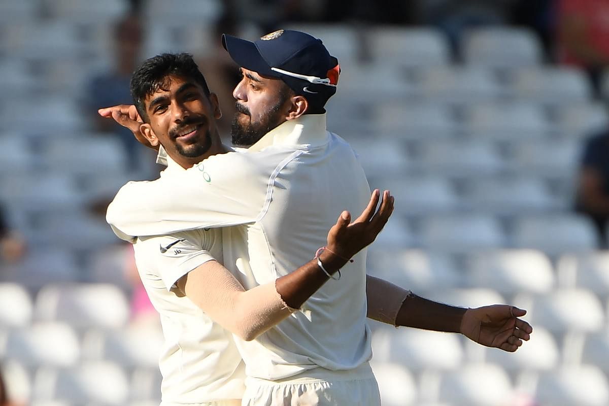 On FIRE: India's Jasprit Bumrah (left) celebrates with K L Rahul after dismissing England's Jos Buttler on Tuesday. AFP