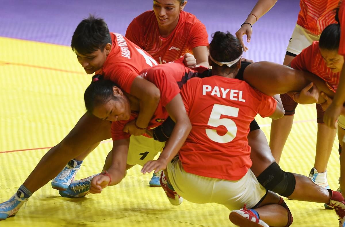 NO WAY OUT Indian players tackle Indonesia’s Laraswati Ni Putu Dewi (centre) during their clash on Tuesday. AFP