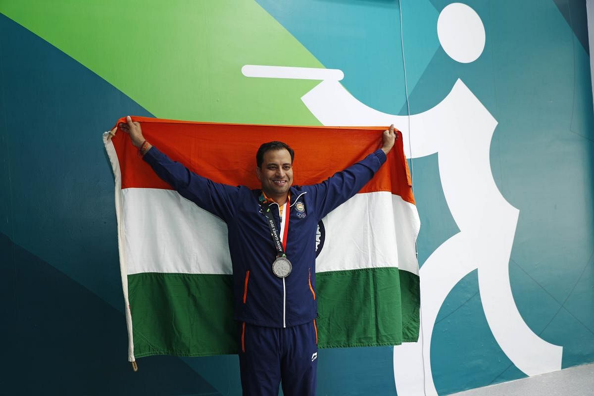 Silver medallist Sanjeev Rajput of India holds up his national flag. Reuters photo