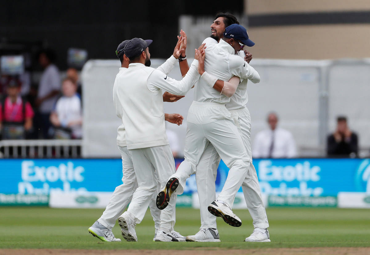 Ishant Sharma celebrates with teammates after taking the wicket of England's Alastair Cook. Reuters file photo