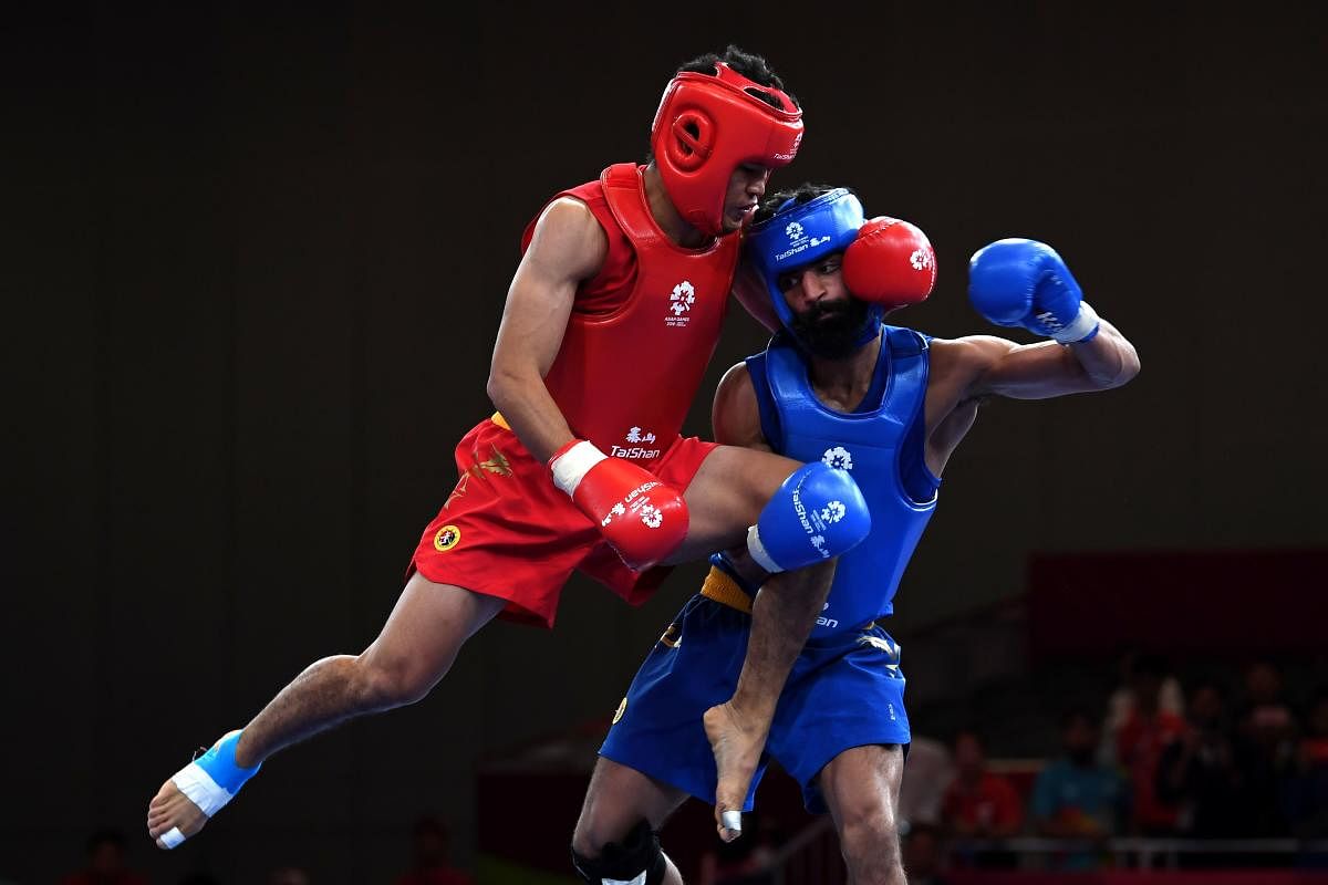 India’s Surya Bhanu Partap Singh (right) lost his match in the 60 kg class against Iran’s Erfan Ahangarian. AFP FILE PHOTO