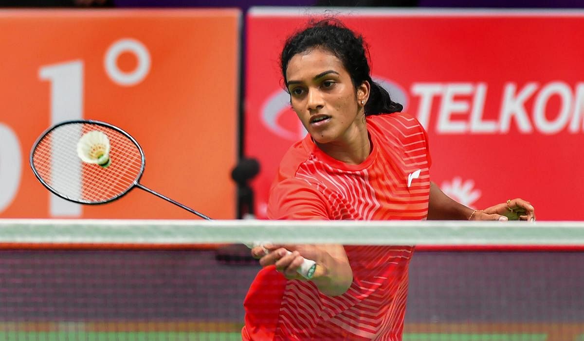 STRUGGLE: India's PV Sindhu in action against Vu Thi Trang of Vietnam in the women's singles badminton match in Jakarta on Thursday. PTI