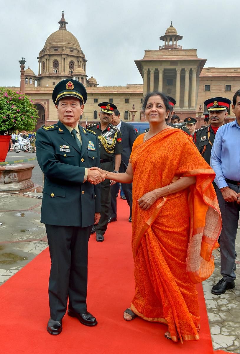 Defence Minister Nirmala Sitharaman welcomes her Chinese counterpart General Wei Fenghe at the South Block in New Delhi on Thursday. PTI