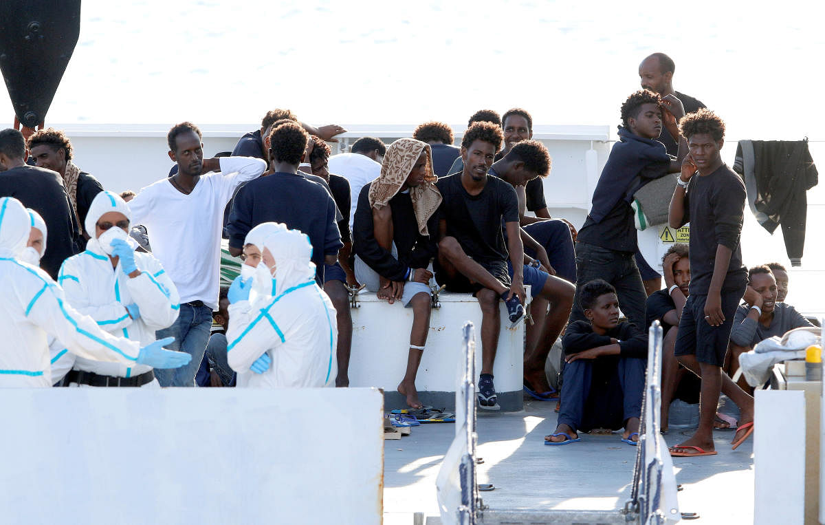 Migrants wait to disembark from the Italian coast guard vessel "Diciotti" at the port of Catania, Italy, August 22, 2018. Reuters