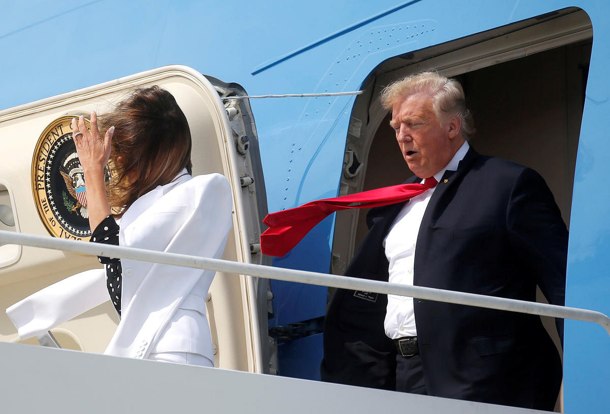 U.S. President Donald Trump and first lady Melania Trump are buffeted by the wind as they emerge from Air Force One arriving in Columbus, Ohio, U.S., August 24, 2018. REUTERS/Leah Millis TPX IMAGES OF THE DAY