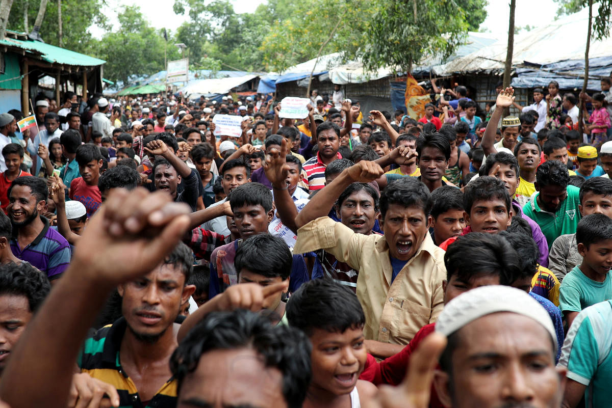 Rohingya refugees shout slogans as they take part in a protest at the Kutupalong refugee camp to mark the one year anniversary of their exodus in Cox's Bazar, Bangladesh August 25, 2018. (REUTERS)