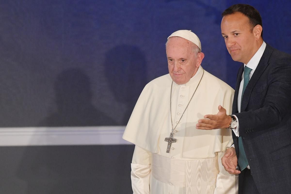 Ireland's Prime Minister Leo Varadkar shows the way to Pope Francis in St Patricks Hall in Dublin Castle in Dublin on August 25, 2018. AFP