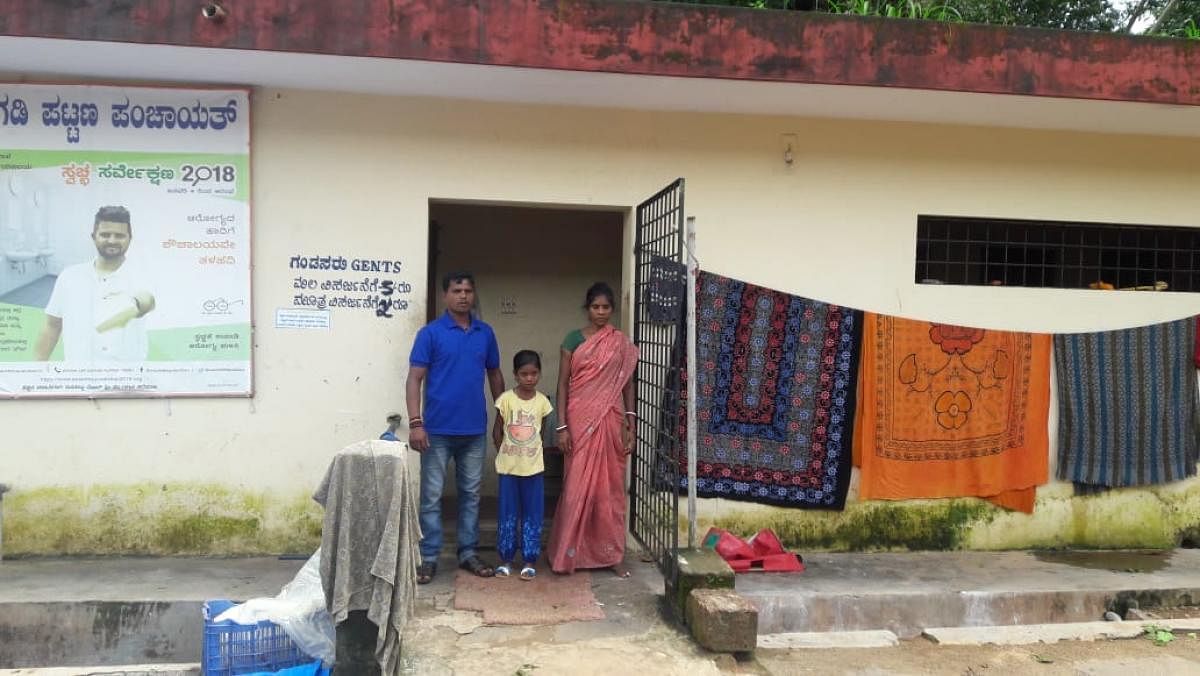 A civic worker’s family has made a public toilet their home.