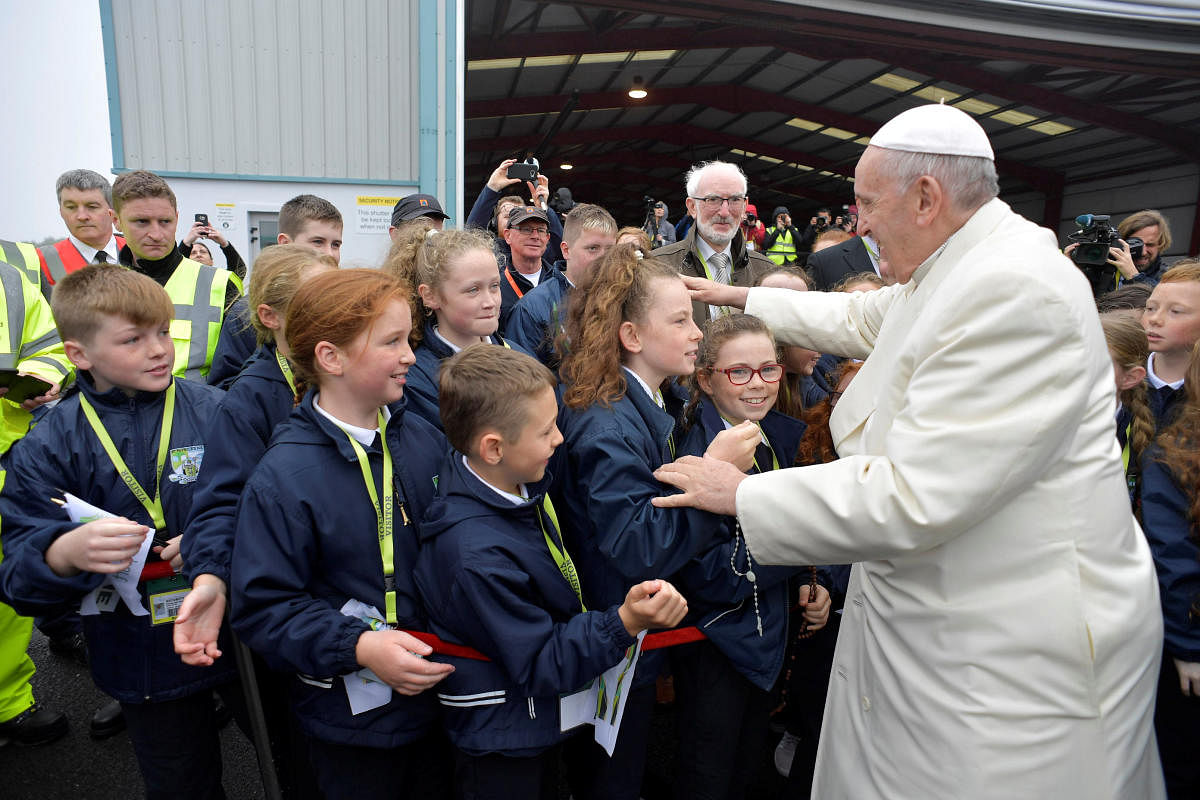 Pope Francis greets children after arriving in Knock, Ireland August 26, 2018. Vatican Media/Handout via REUTERS